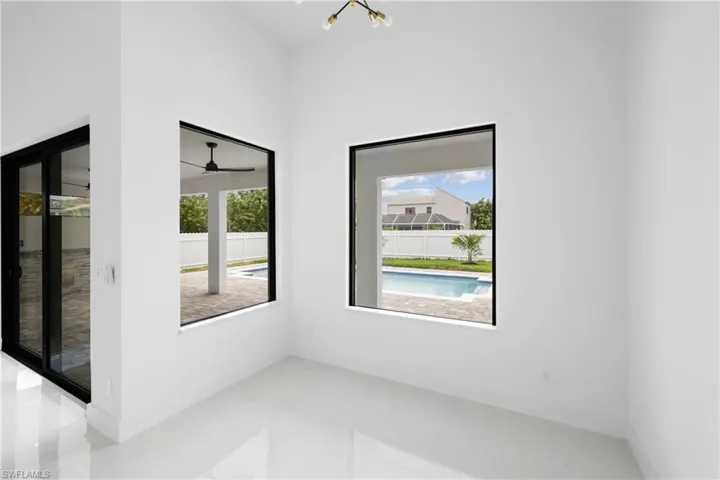 Tiled spare room with ceiling fan