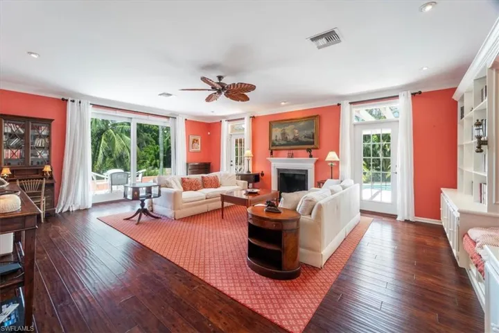 Living area with a fireplace & classic artwork.