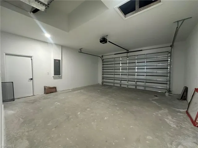 Garage featuring a garage door opener