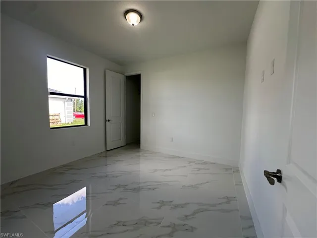 Spare room featuring light tile floors