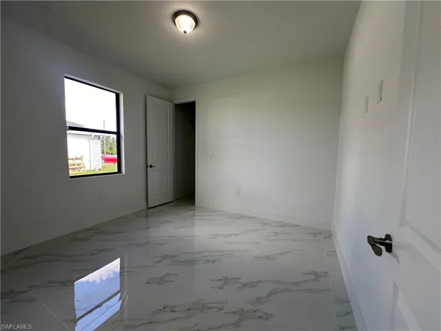 Empty room featuring light tile floors