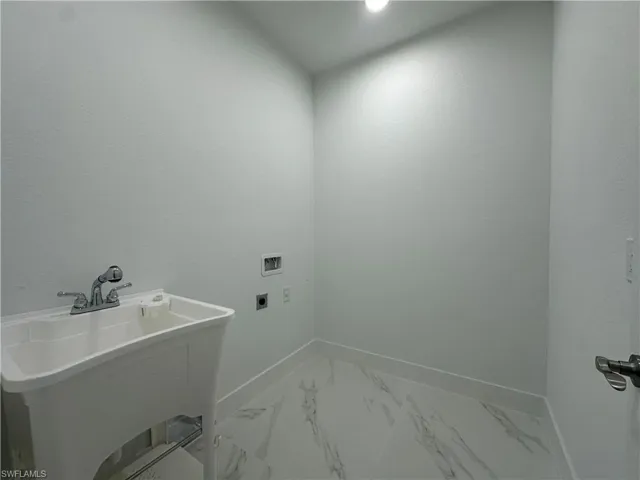 Laundry area featuring sink and hookup for a washing machine