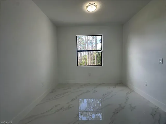 Spare room featuring tile floors