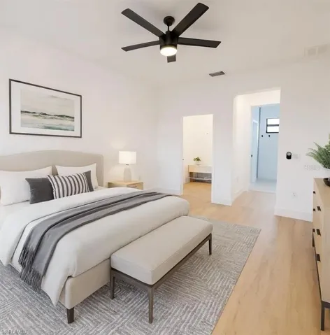 Bedroom featuring light wood-style flooring, connected bathroom, and a ceiling fan
