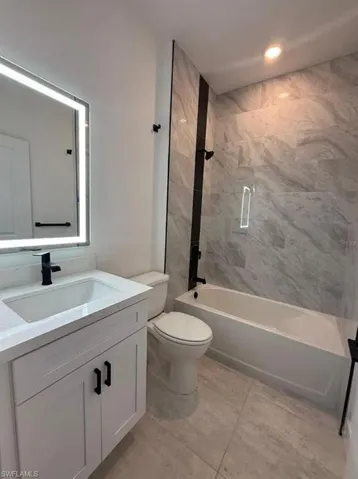 Full bath with vanity and tub / shower combination