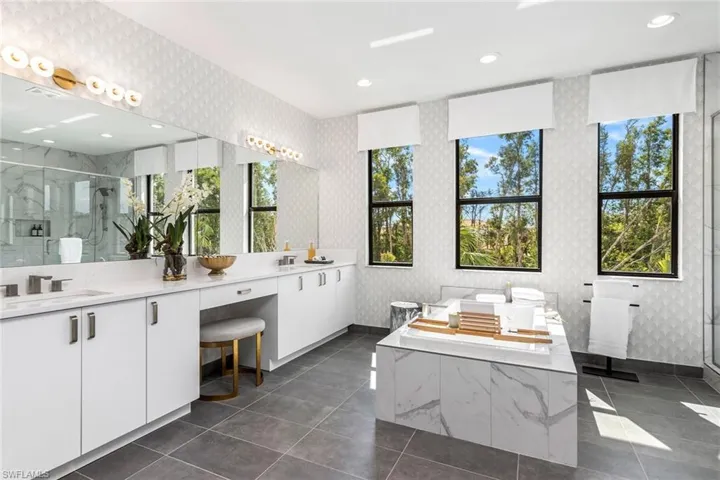 Bathroom featuring vanity, tile patterned floors, and separate shower and tub