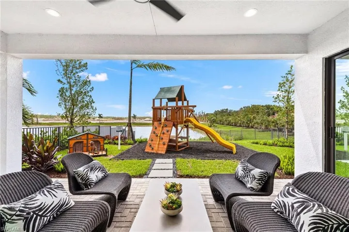 View of patio / terrace featuring ceiling fan and a playground