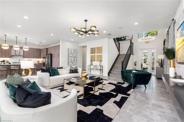 Tiled living room featuring a notable chandelier