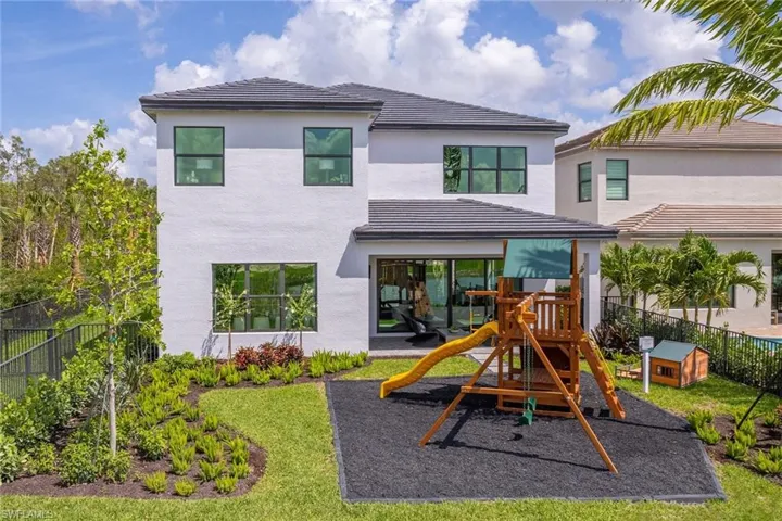Rear view of property featuring a playground