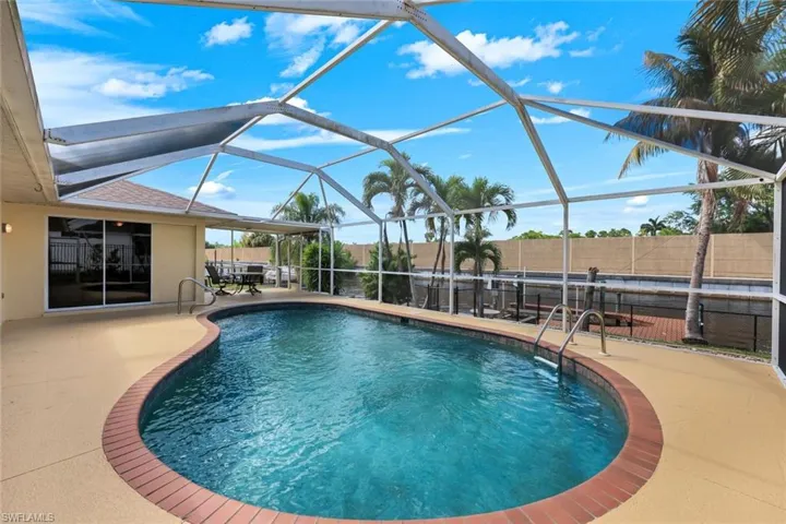 Heated free-formed swimming pool with brick cooping