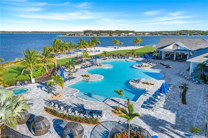 Community pool featuring a patio area and a water view