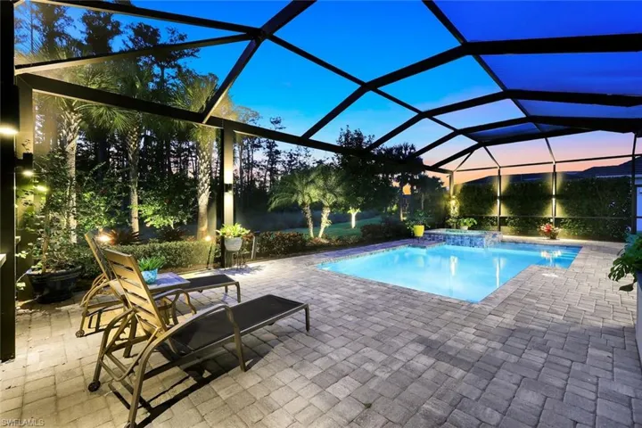 Swimming pool with a lanai, a patio, a sunroom, and a jacuzzi