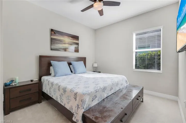 Bedroom with light carpet and ceiling fan