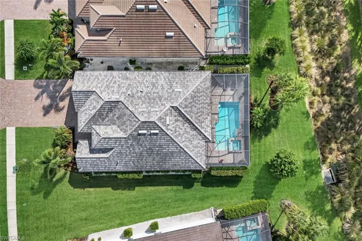 Aerial view of property and surrounding area featuring a pool area