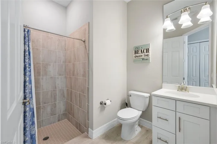 Full bathroom featuring a stall shower and vanity