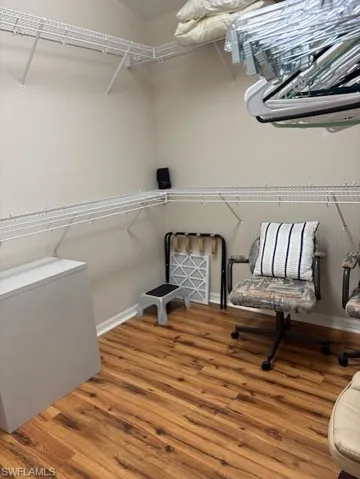 Walk in closet featuring wood finished floors