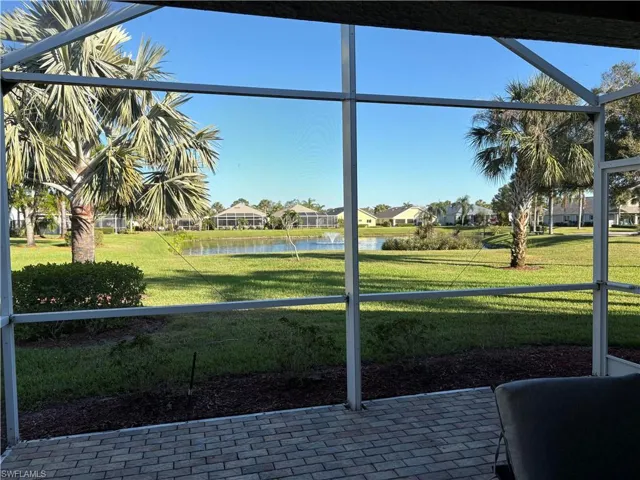 Furnished sunroom featuring a healthy amount of sunlight and a water view