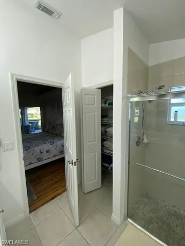 Bathroom featuring tile patterned floors and walk in shower