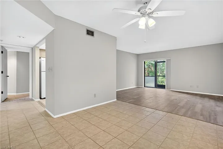 Empty room with ceiling fan and light tile patterned floors