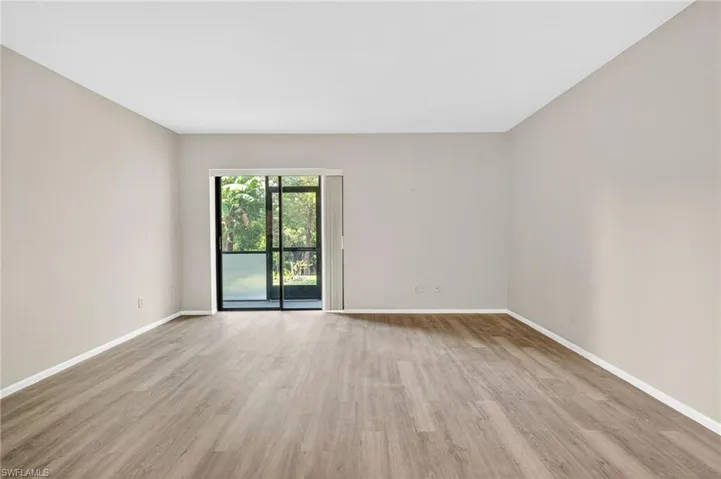 Unfurnished room featuring light wood-style flooring and baseboards
