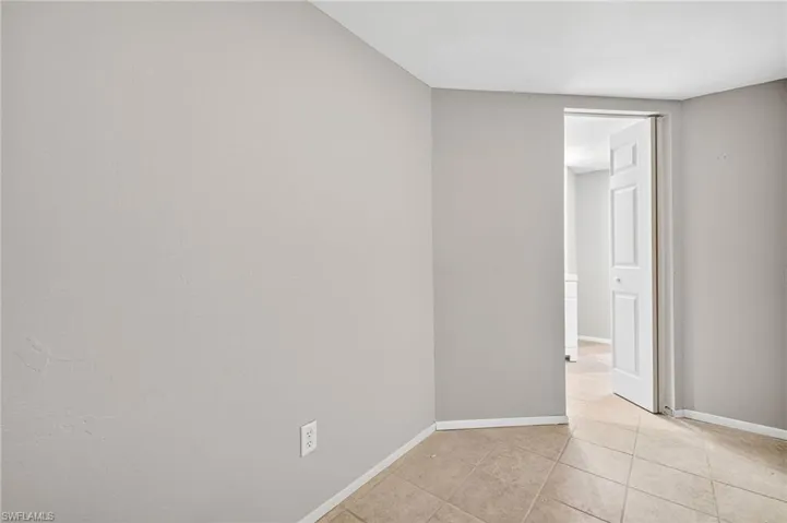 Spare room featuring baseboards and light tile patterned floors