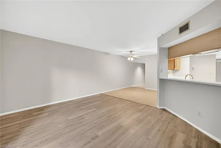 Unfurnished living room featuring ceiling fan and light wood-type flooring
