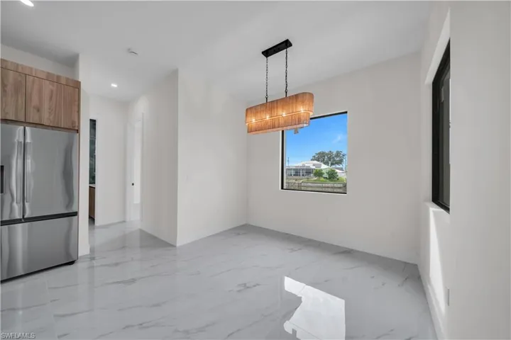 Unfurnished dining area with light marble finish flooring and recessed lighting