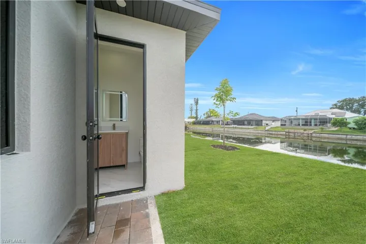 View of green lawn featuring a water view and a residential view