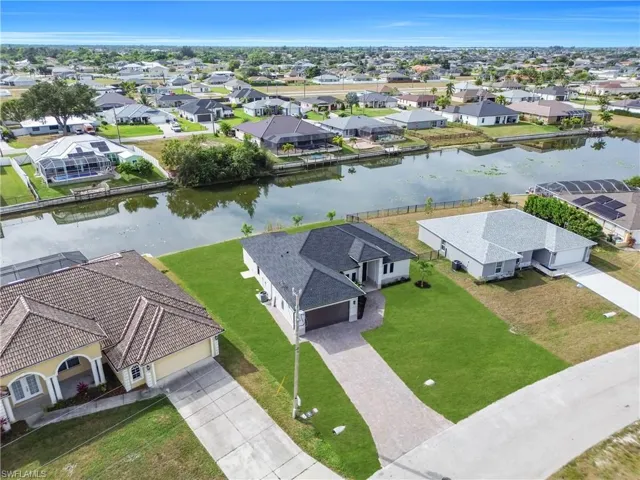 Aerial perspective of suburban area with a nearby body of water