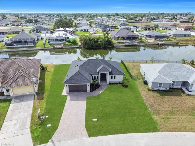 Aerial view of residential area featuring a nearby body of water