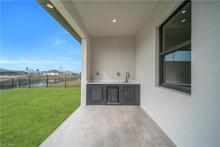 Fenced backyard featuring a patio area and a water view