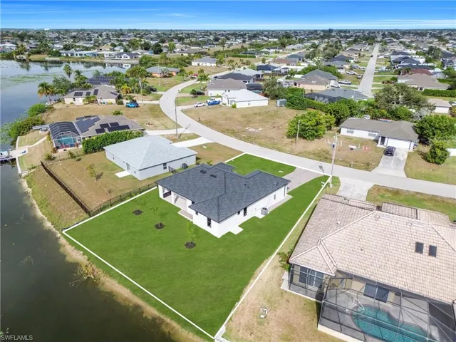 Aerial perspective of suburban area with a nearby body of water
