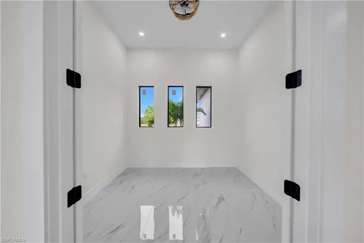 Spare room featuring light marble finish floors and recessed lighting