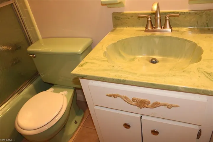 Bathroom with tile patterned floors, vanity, and toilet