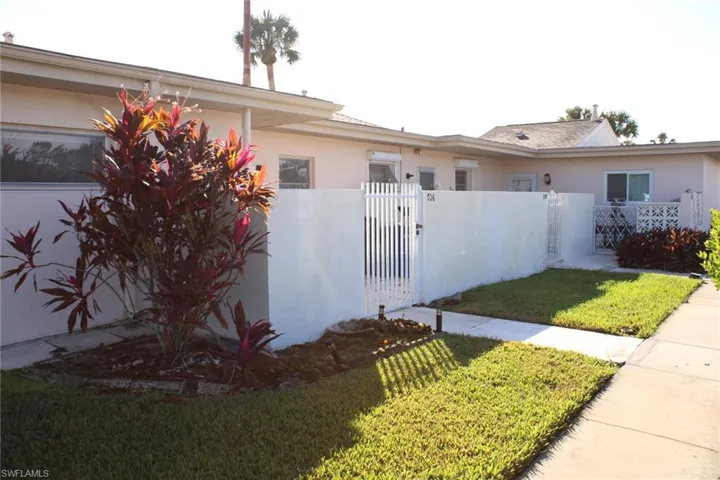 View of side of home with a lawn