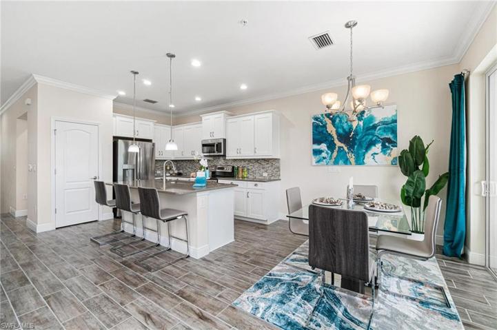 Kitchen area with large pantry, and dining area with lake view.