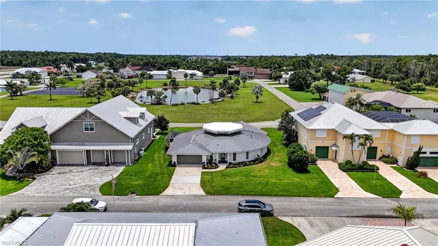 Aerial perspective of a neighborhood featuring diverse architectural styles and manicured lawns