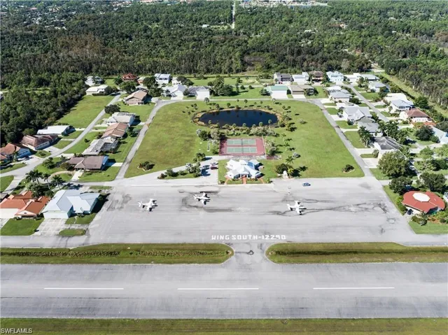 Aerial perspective showcasing a residential community with direct airfield access