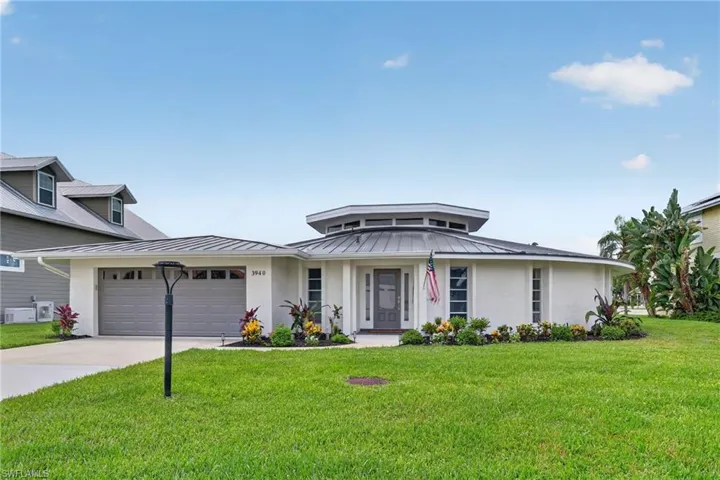 Contemporary architectural design featuring a circular main structure and a metal roof