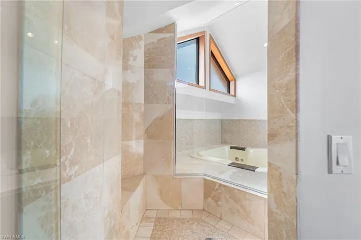 Bathroom featuring a bath and tile patterned flooring