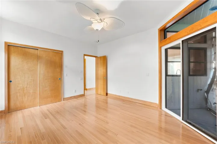 Unfurnished bedroom with light wood finished floors, a closet, and a ceiling fan