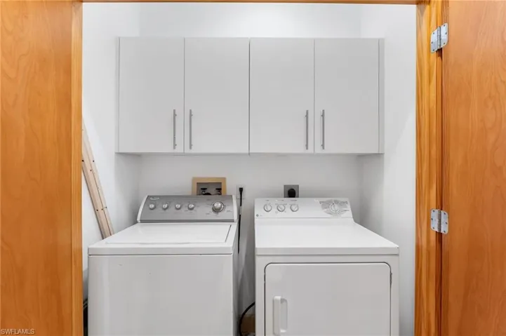 Washroom with cabinet space and separate washer and dryer