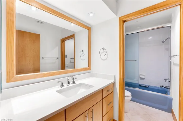 Full bath with vanity, tile patterned flooring, shower / washtub combination, and recessed lighting