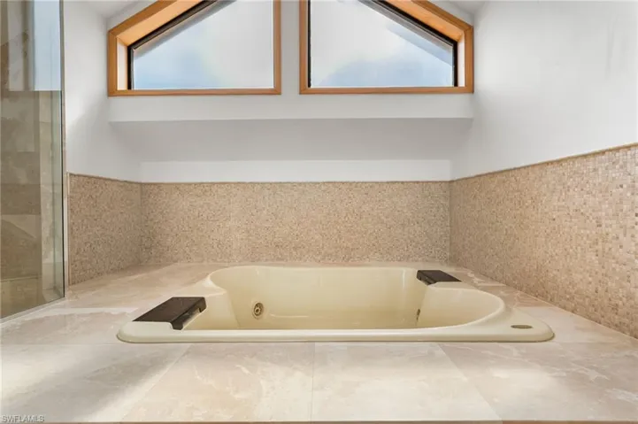 Bathroom featuring a whirlpool tub and wainscoting