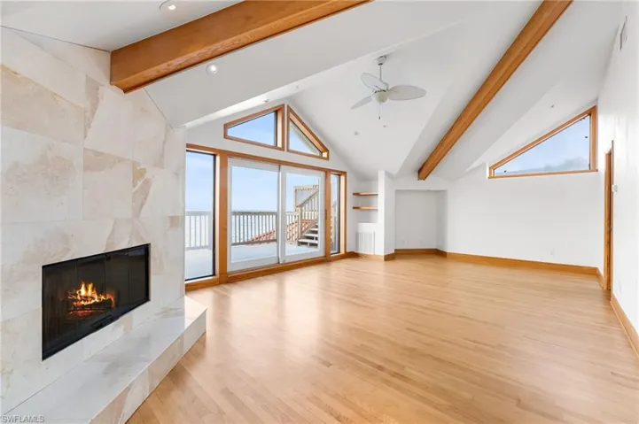 Master bedroom featuring light wood-type flooring, ceiling fan, a fireplace, healthy amount of natural light, and recessed lighting