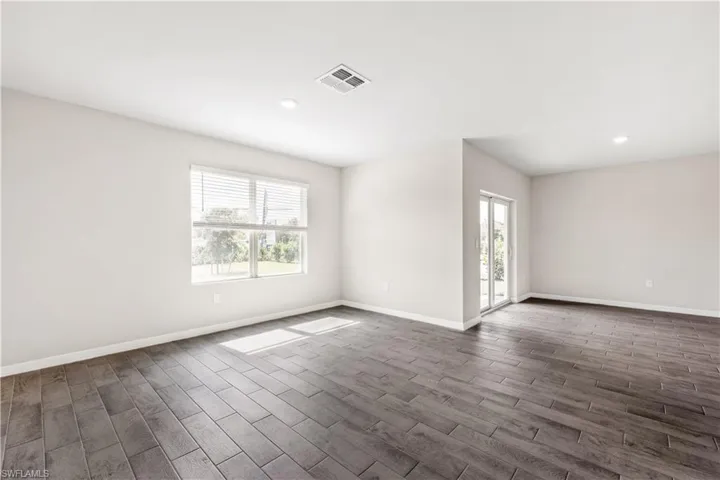 Spare room with dark wood-type flooring