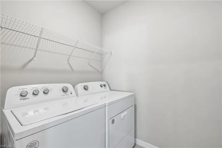 Washroom with washing machine and clothes dryer