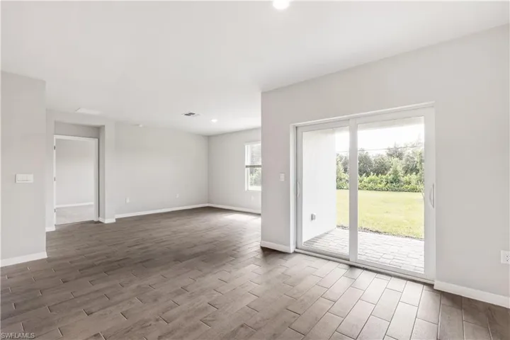 Spare room featuring dark wood-type flooring