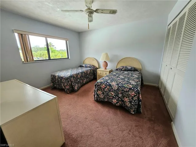 2ND Bedroom featuring ceiling fan, a textured ceiling, a closet, and dark colored carpet