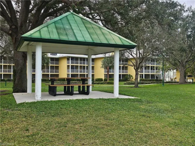 View of property's community with a gazebo and a lawn